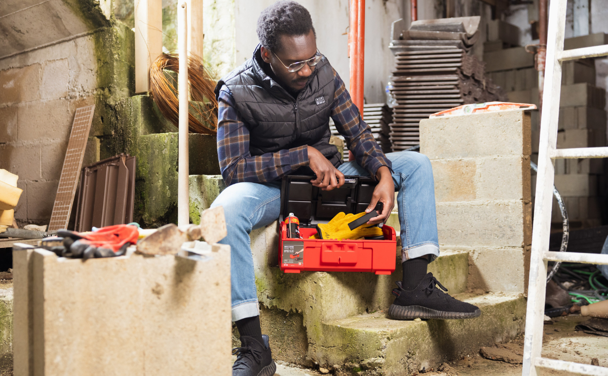 A man prepares to hide a Classic GPS Tracker in a toolbox